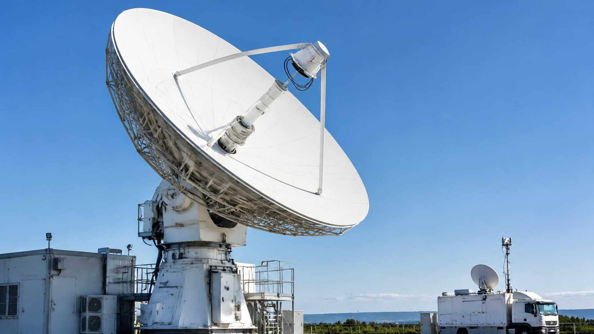 Satellite uplink dish against the sky